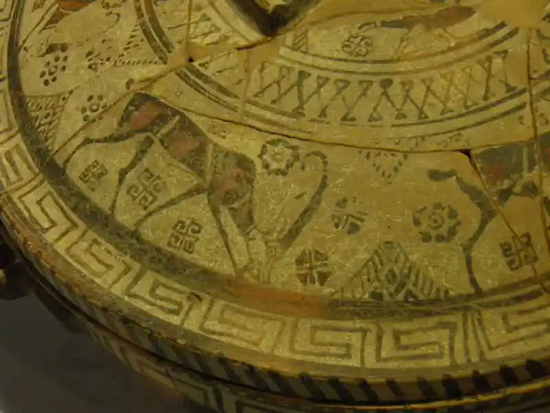 Goats eating around a lid. There are also different kinds of solar crosses and swastikas and other sun symbols around it.